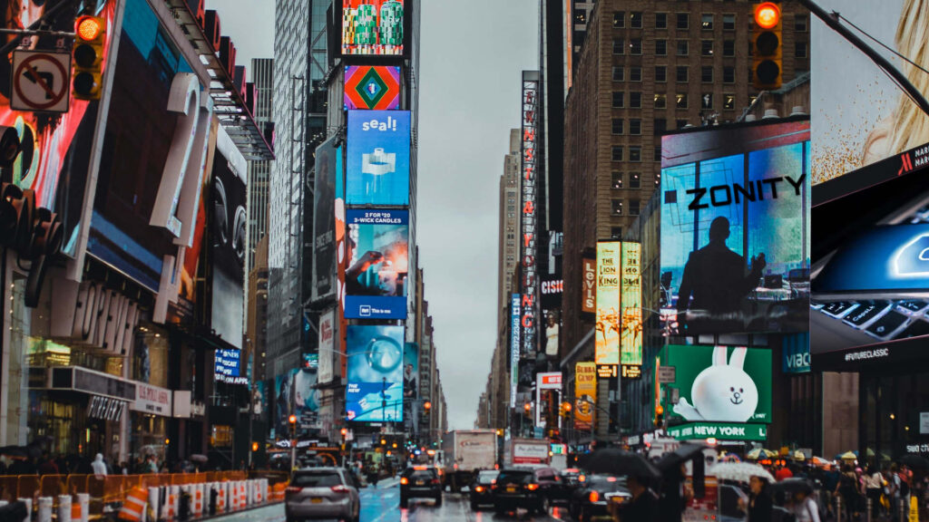 Zonity Contact form, city street with a lot of traffic and people walking, time square, digital billboard in the middle, neon signs in background, the city that never sleeps.